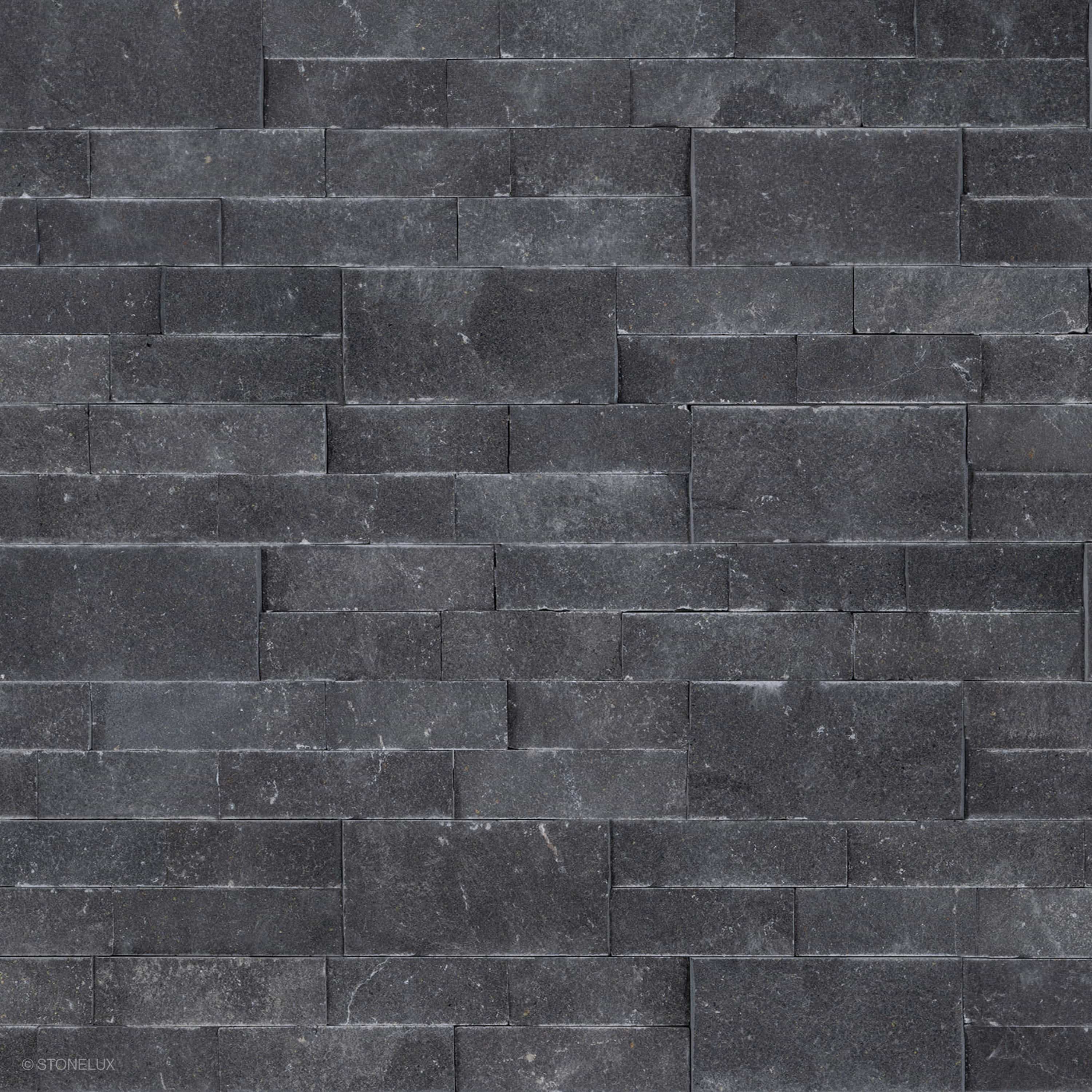 Close-up view of Black Basalt Splitface Ledger Panel - 6x24 by STONELUX, showcasing the natural basalt texture with rich dark tones and a rugged, splitface finish. Ideal for wall veneers, offering a sophisticated, modern aesthetic for hardscape projects.
