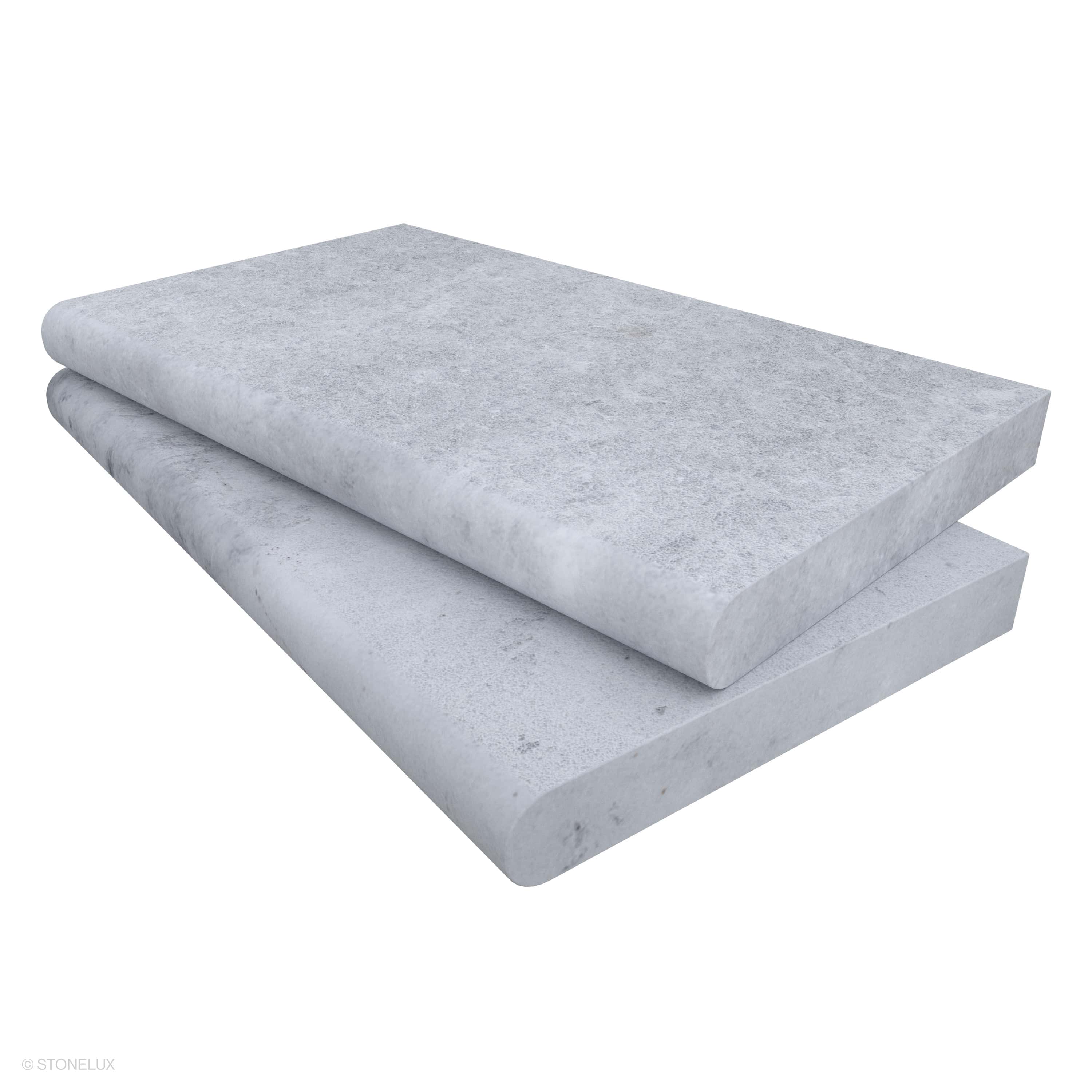 Close-up of the Tundra Grey Marble Sand Blasted 14x24x2 Single Bullnose Coping by STONELUX. This marble piece features a sandblasted finish with subtle grey texture and veining, ideal for pool edges and wall caps, highlighting its premium stone quality.