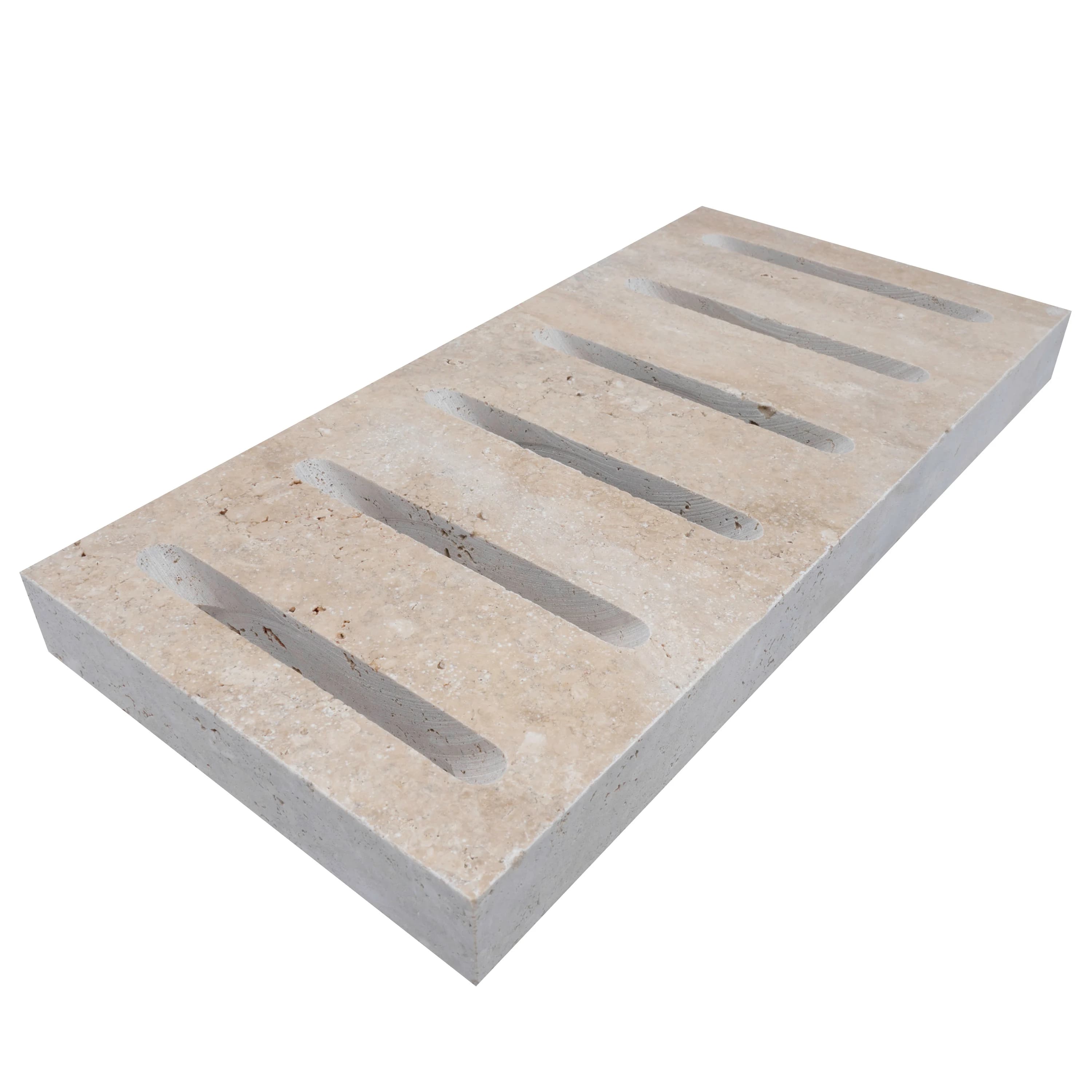 Close-up of Walnut Travertine Tumbled 6x12x3cm Drain Decor - Premium. This natural stone features a warm beige hue with subtle veining and a textured, tumbled finish, ideal for enhancing outdoor hardscape projects with its elegant and functional design.