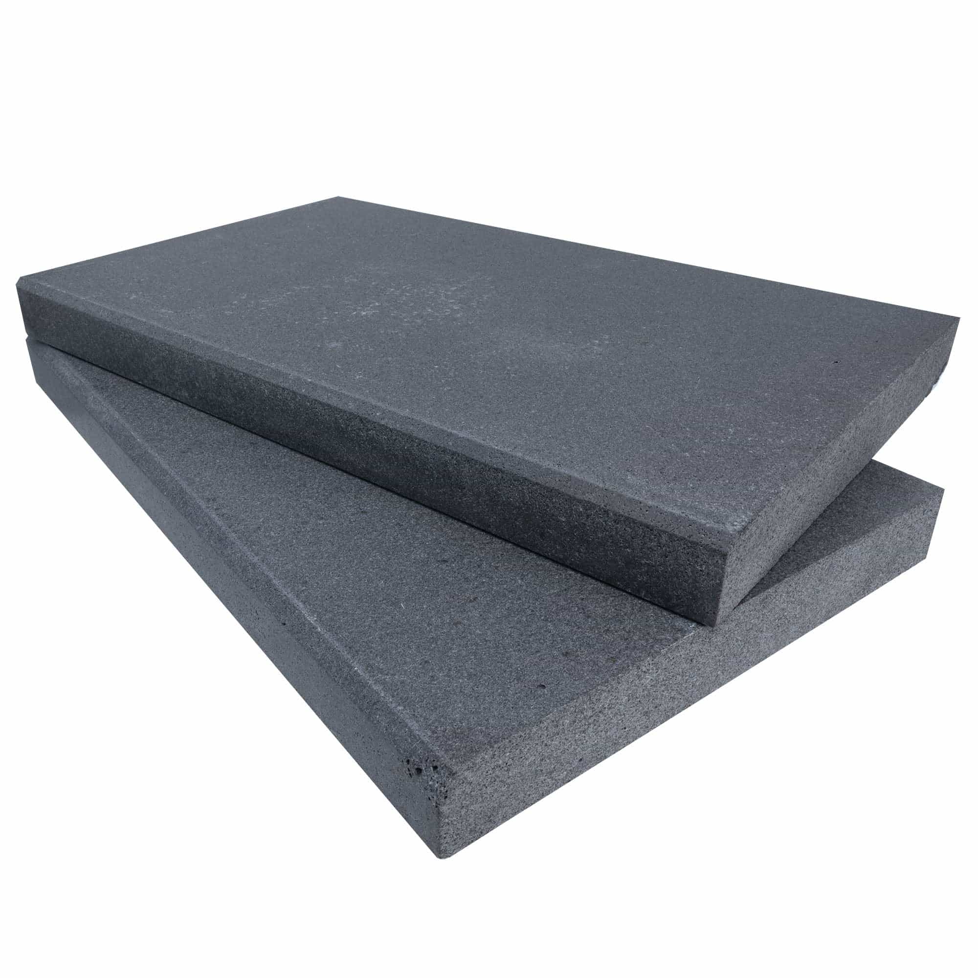 Close-up of Black Basalt Tumbled+Brushed 14x24x2 Eased Edge Coping by STONELUX. This natural stone features a textured, dark gray surface with a smooth beveled edge, ideal for pool coping or patio projects. Durable and elegant for modern hardscapes.