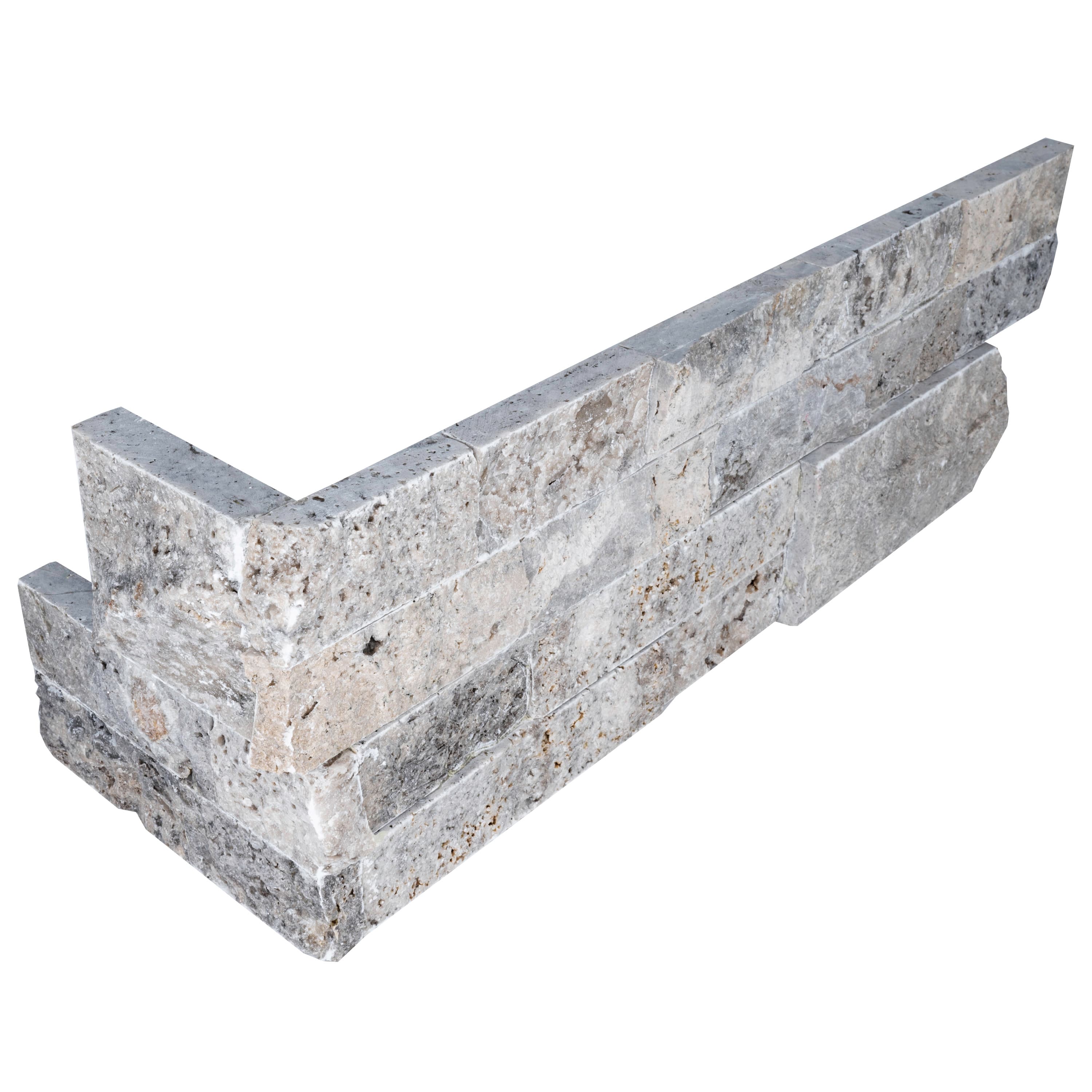 Close-up image of the Silver Travertine Splitface Ledger Panel Corner, 6x18, showcasing its natural stone texture and varied gray tones. The splitface finish highlights the travertine's unique veining and rugged surface, ideal for elegant hardscape pro...