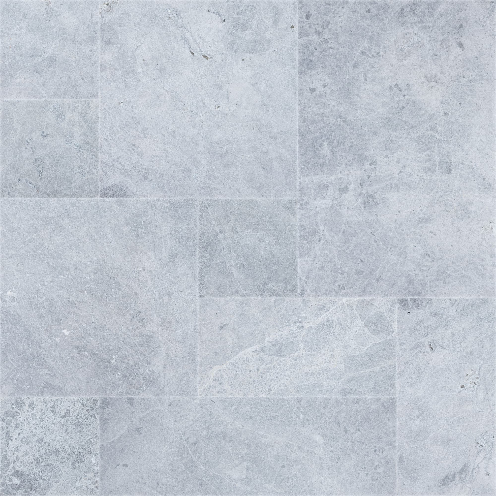 Close-up of Tundra Grey Marble Sand Blasted French Pattern 3cm Paver, showcasing a natural stone surface with subtle grey veining and a textured sandblasted finish. Ideal for elegant hardscape projects and pool decks, highlighting its premium marble qu...