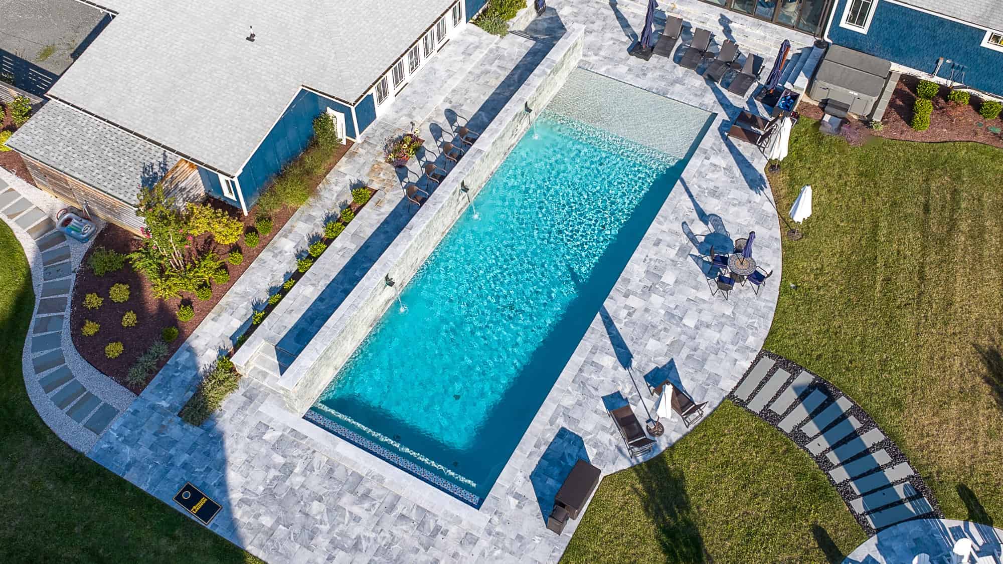 Arctic Grey Marble pool coping and marble pavers installed around a residential pool and patio in Purcellville, VA.