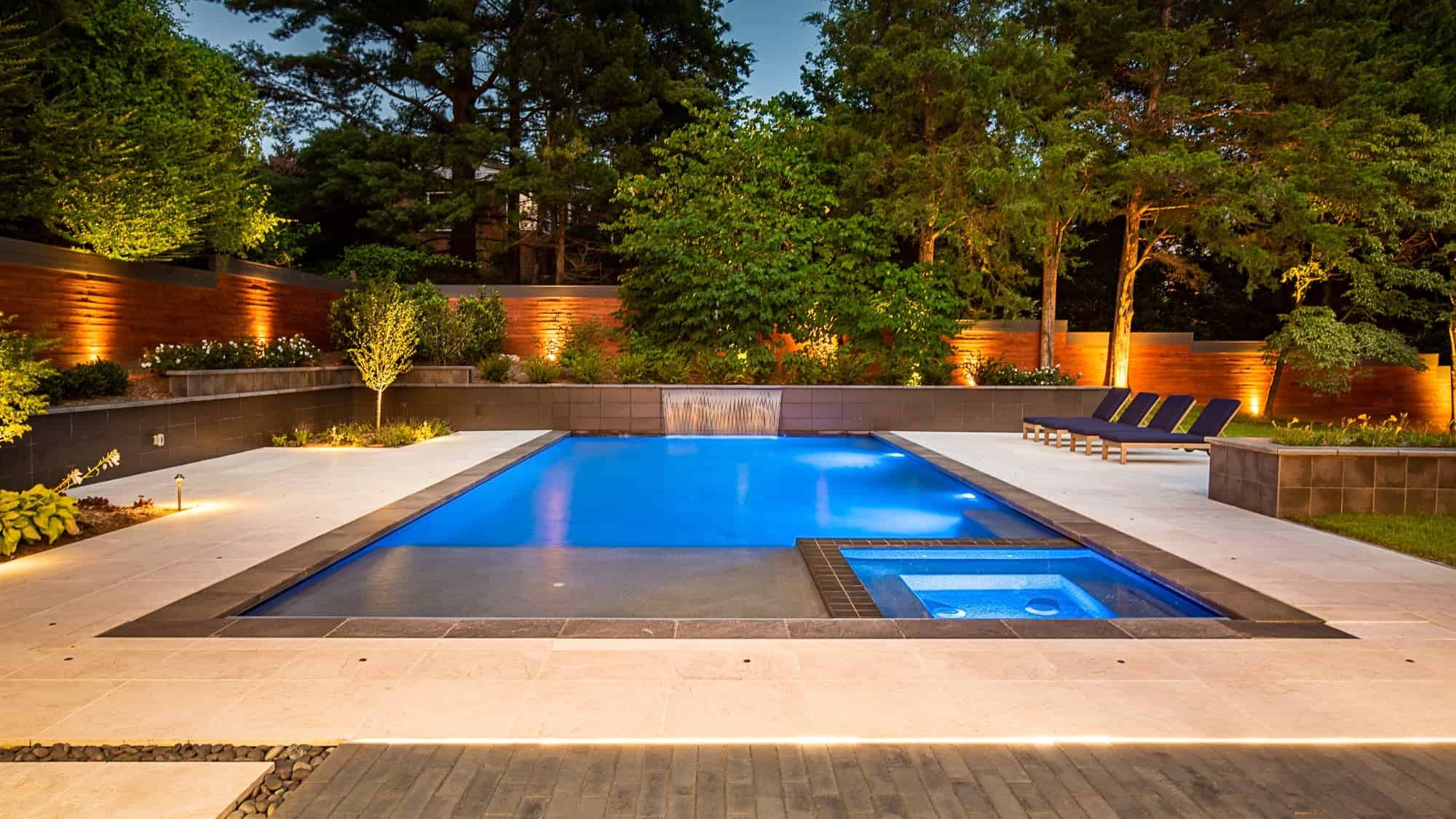 Pera Cream Marble sandblasted pavers installed around a modern pool deck and patio in McLean, VA.