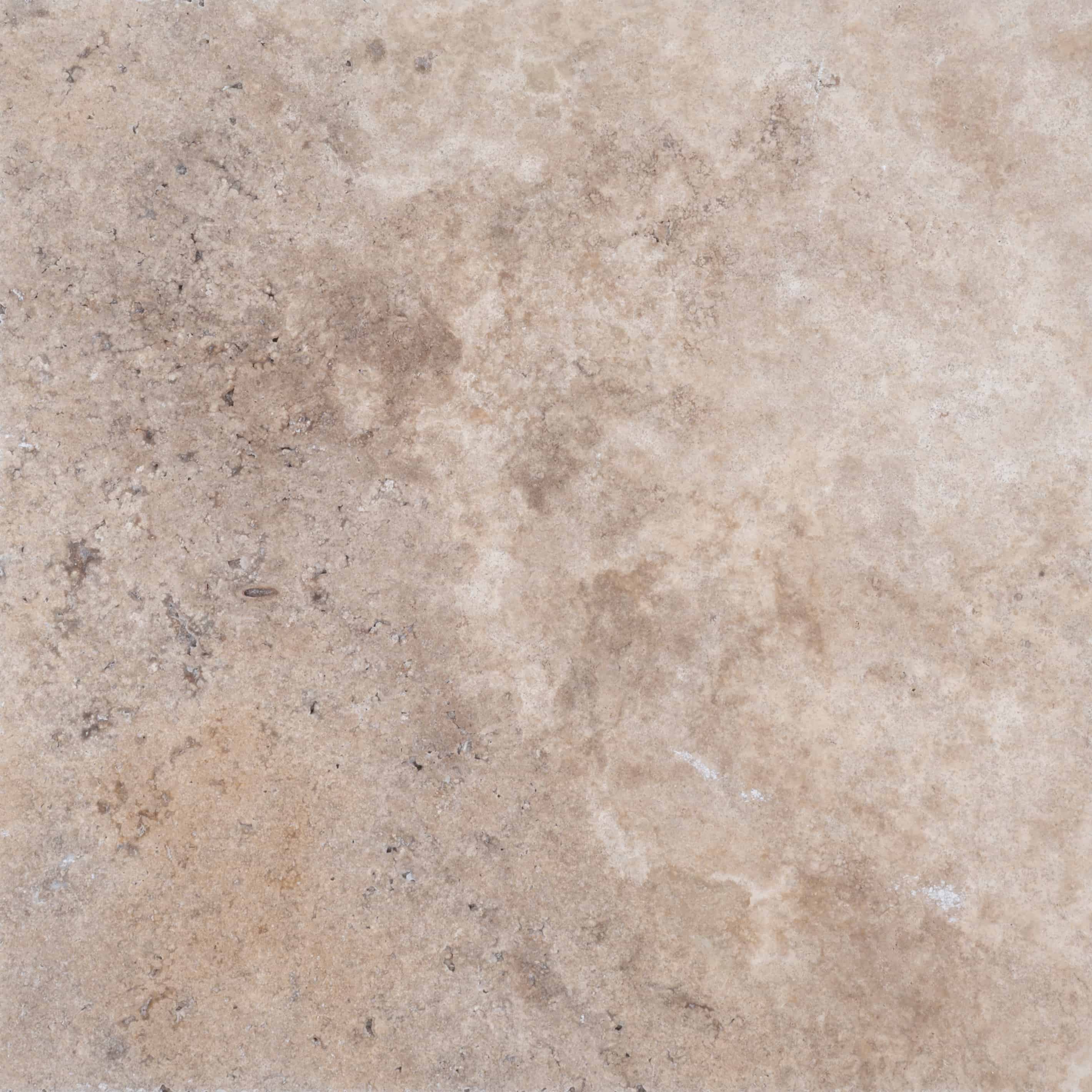 Close-up of Philly Travertine natural stone from STONELUX, showcasing a textured surface with beige and taupe hues, subtle veining, and a rustic appearance. Ideal for hardscape projects and pool renovations with a timeless, elegant finish.