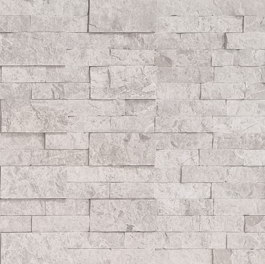 Close-up of the Pera Cream Marble Splitface Ledger Panel (6x24) showcasing its natural stone texture and creamy beige tones. The marble's splitface finish highlights subtle veining and varied surface characteristics, ideal for elegant wall installations.