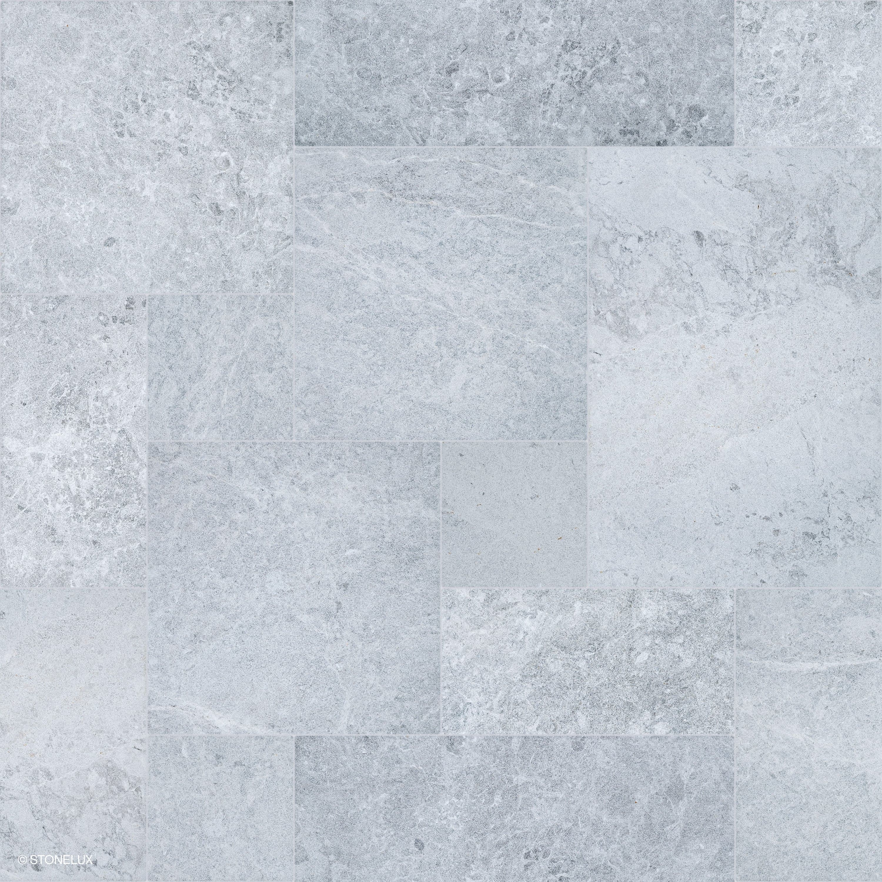 Close-up of Tundra Grey Marble Sand Blasted French Pattern 3cm Paver by STONELUX. Features a subtle grey tone with a sandblasted texture, showcasing natural veining and a refined matte finish. Ideal for premium hardscape projects and pool decks.