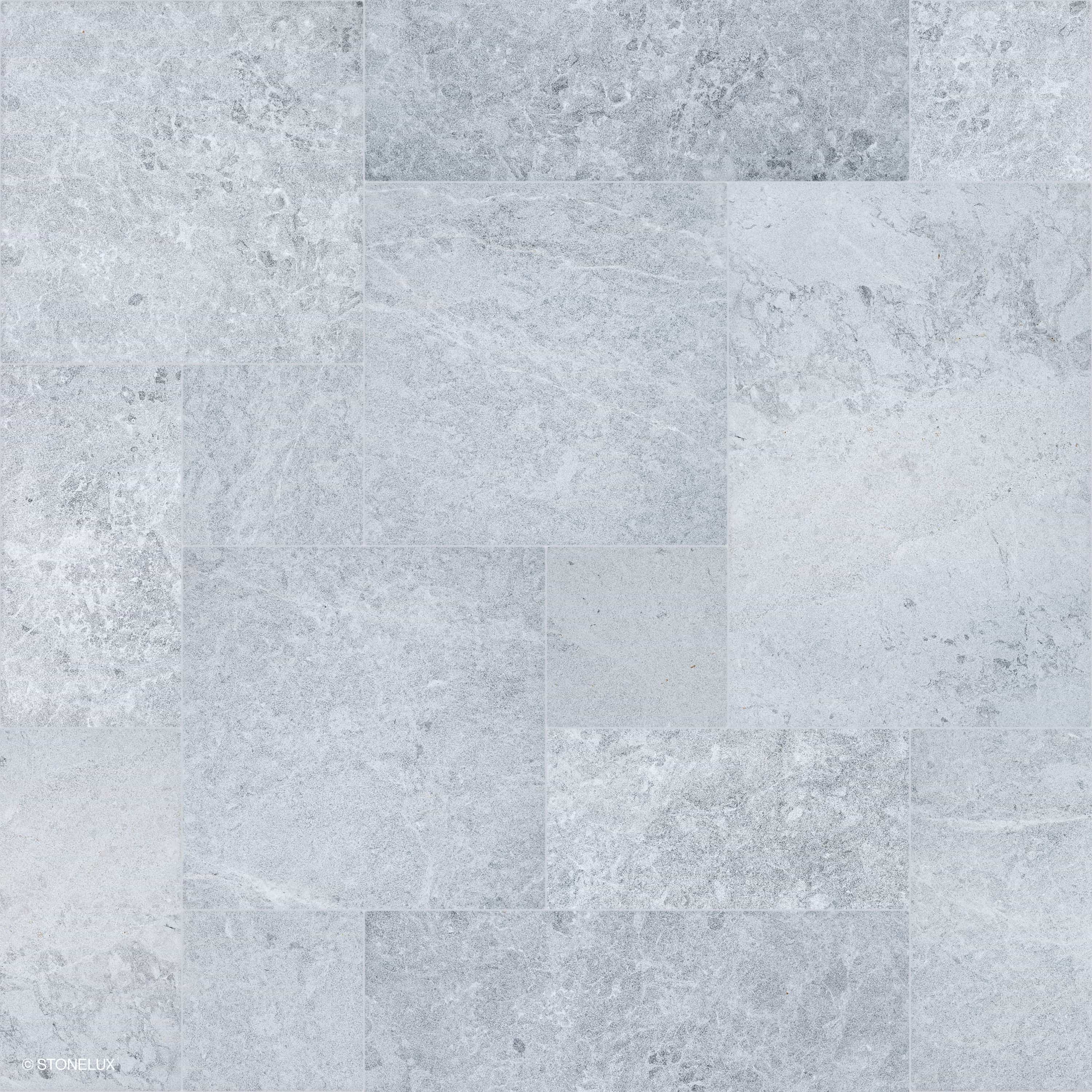 Close-up of Tundra Grey Marble Sand Blasted French Pattern 3cm Paver by STONELUX. Features a subtle grey tone with a sandblasted texture, showcasing natural veining and a refined matte finish. Ideal for premium hardscape projects and pool decks.