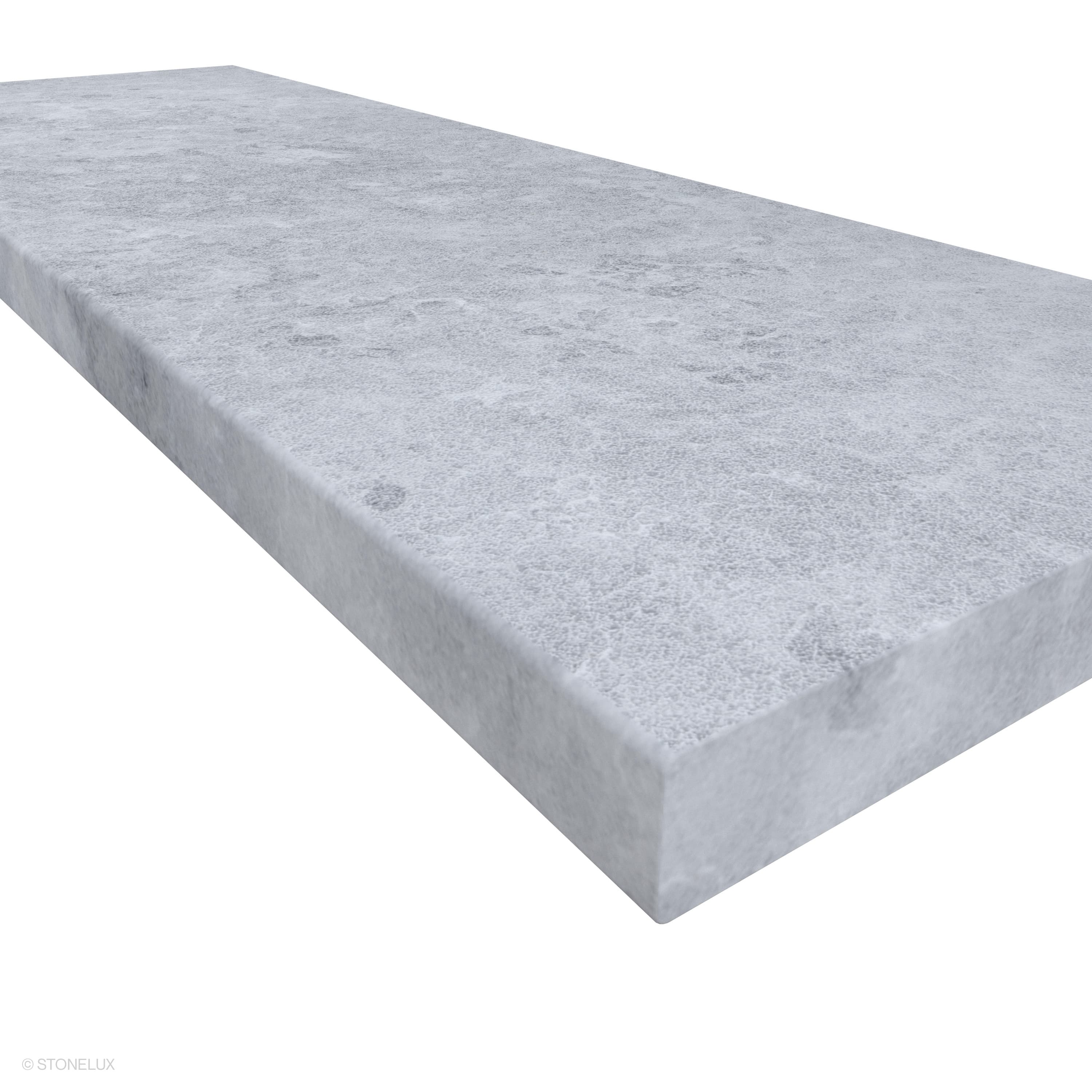 Close-up of STONELUX Tundra Grey Marble Sand Blasted 16x48x2 Eased Edge Coping. The image highlights its subtle grey tones, sandblasted texture, and smooth eased edge profile, ideal for pool edges and hardscape projects.
